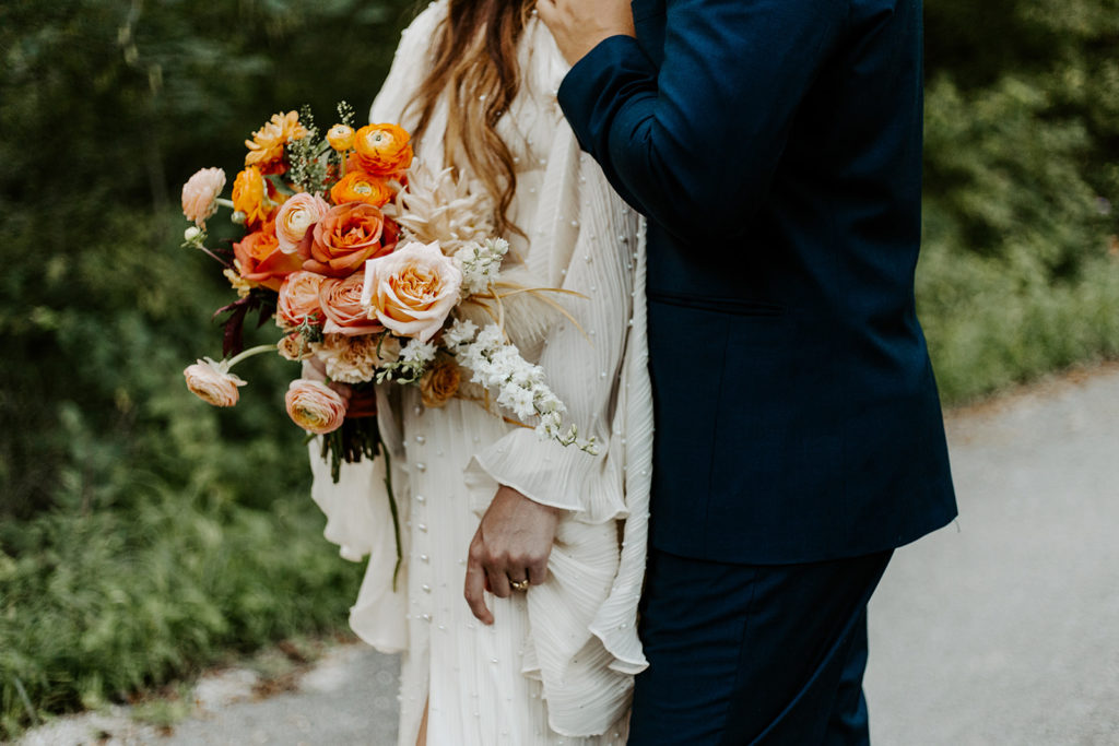 Couple holding warm bridal bouquet