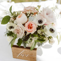 Peach and white centerpiece featuring anemone