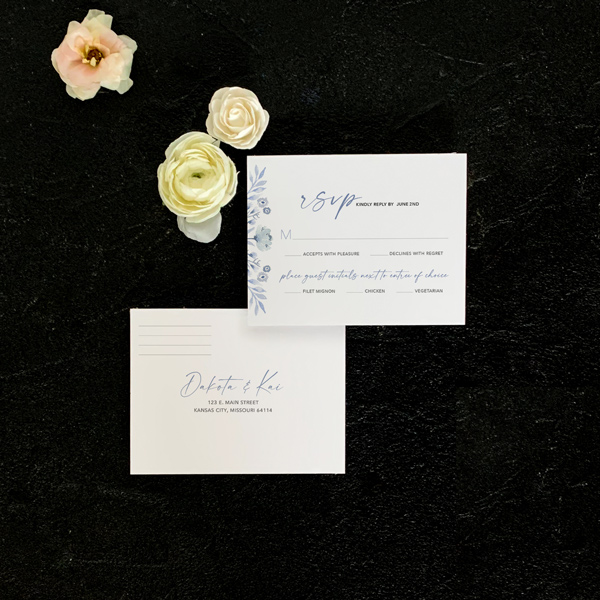 Rose reply card flat lay in blue