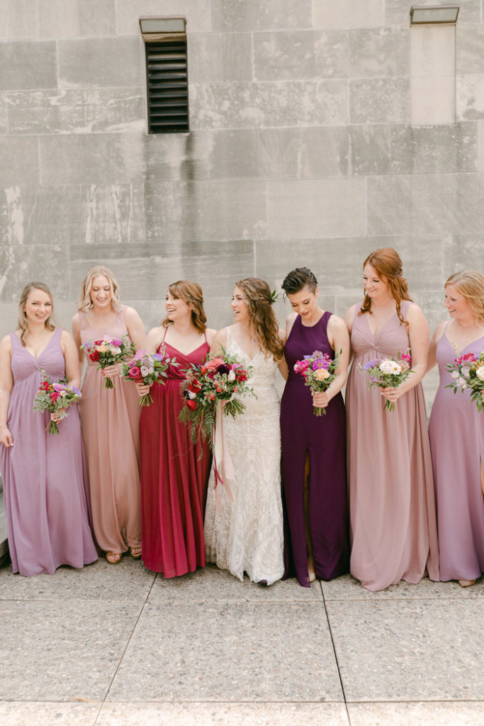 Bridesmaids candidly talking while holding their bouquets