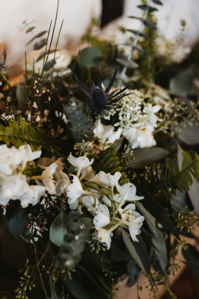 Close-up of bridal bouquet with textural greenery and white wildflowers