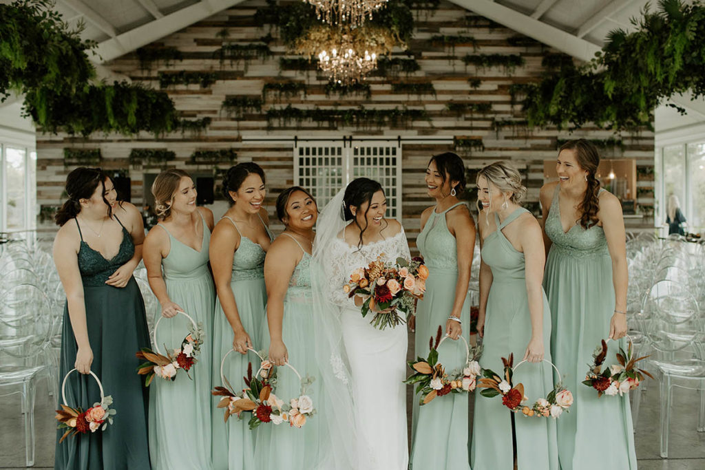 Bridal party holding floral hoops as bouquets