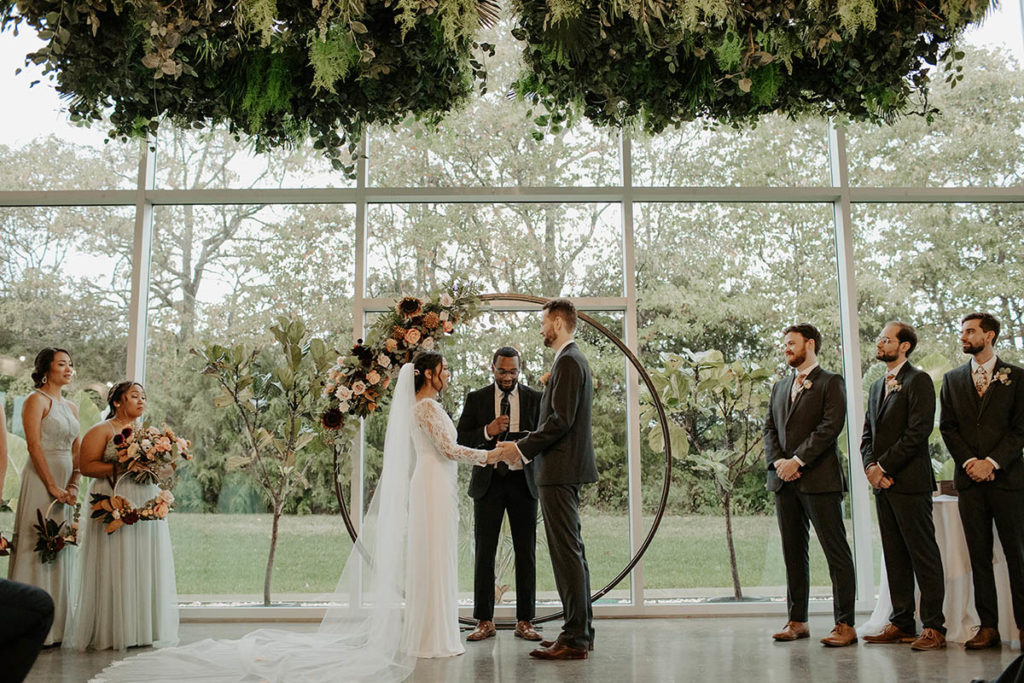 Regina and Josh's wedding ceremony with arbor backdrop