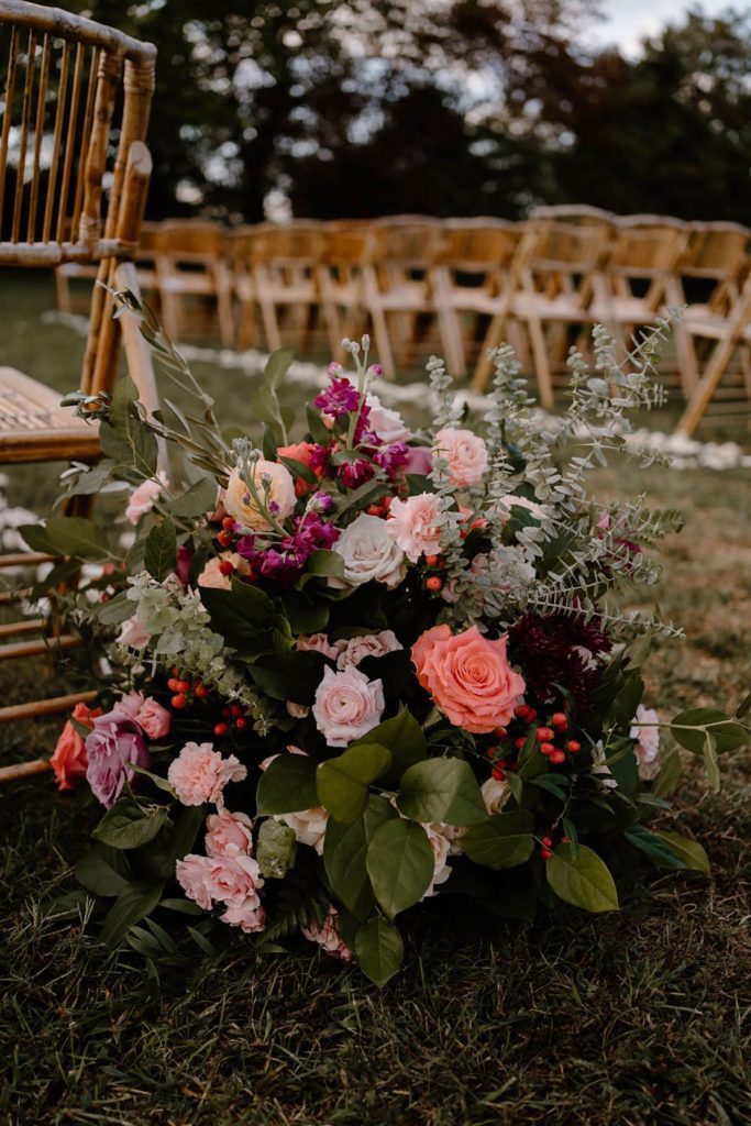 Close up of the floor arrangement at the front of the aisle with pink wedding flowers