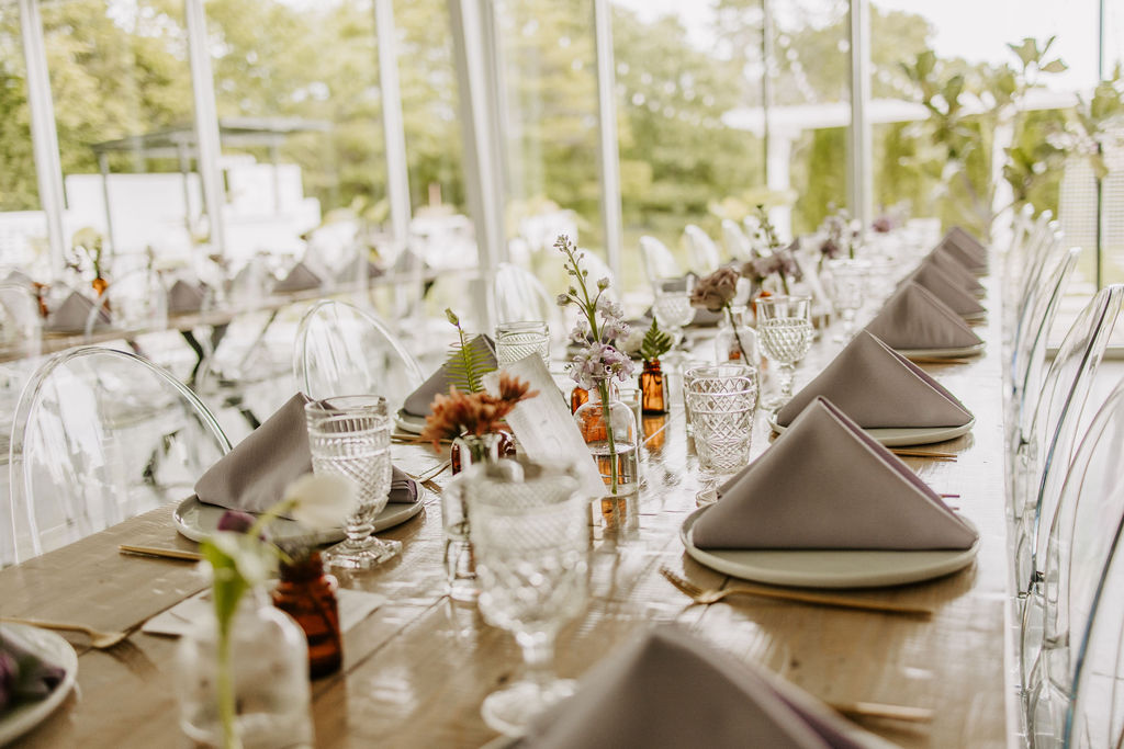 Family-Style Table with lavender napkins and amber bud vases