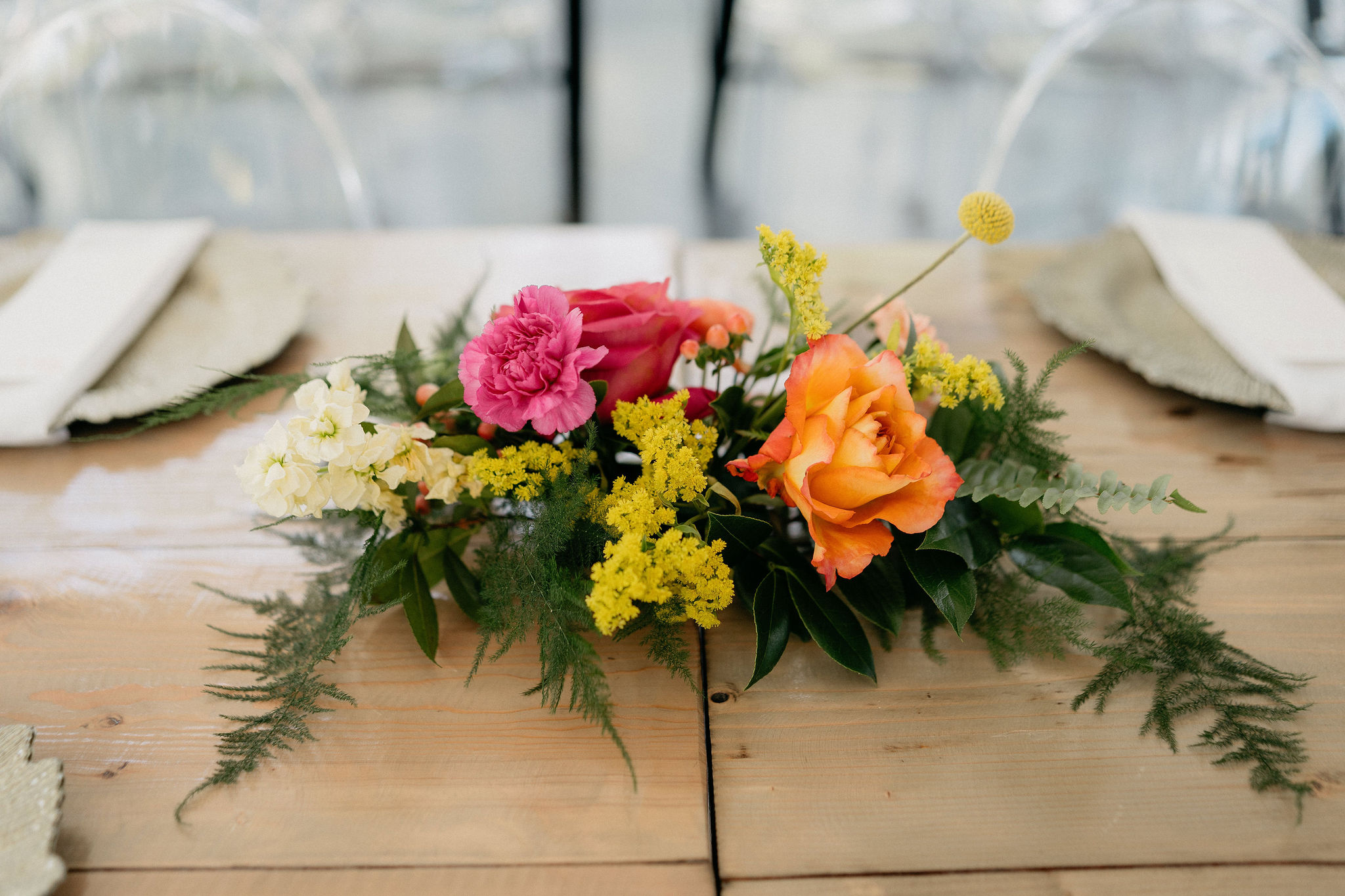 Close up of small table arrangement in magenta, orange, and yellow