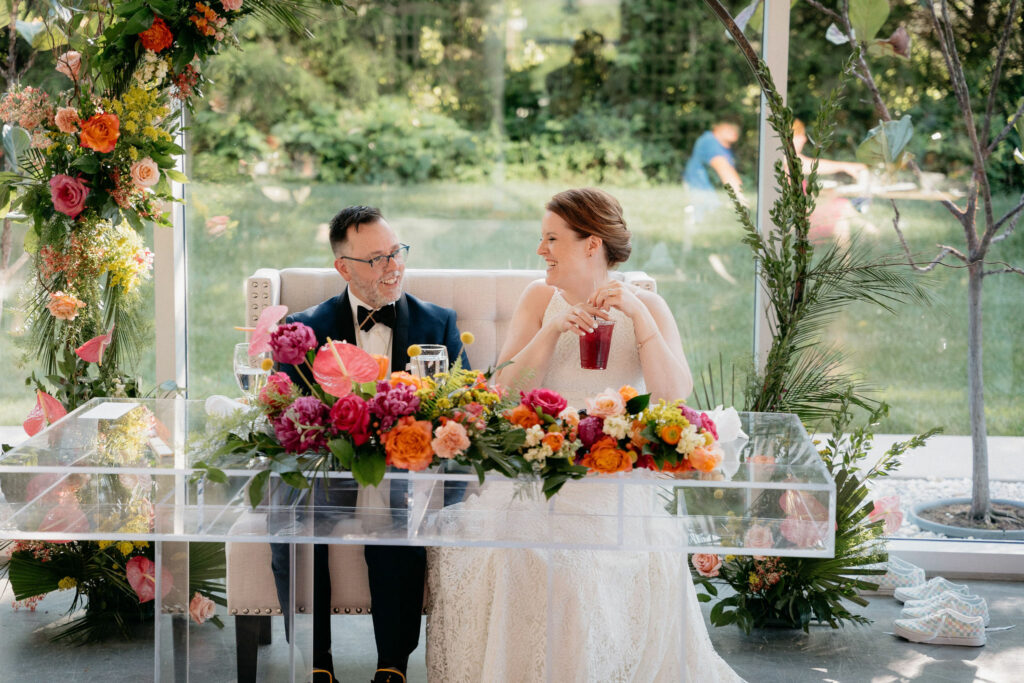 Bride and Groom Smiling at each other at the sweetheart table