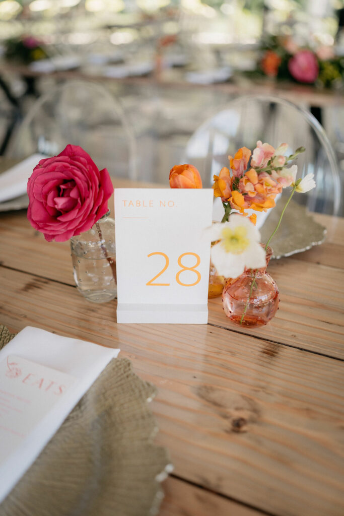Cluster of bud vases with table number in the center