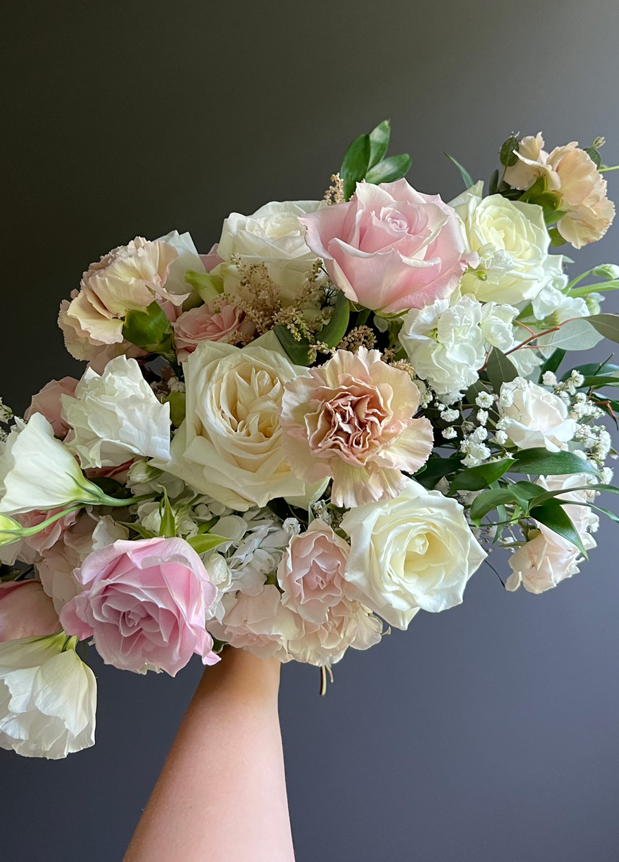 Blush and cream bouquet with roses, baby's breath, and lisianthus