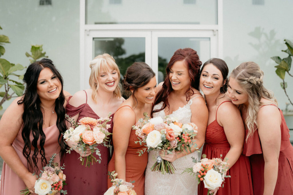 Bride and five bridesmaids holding peach and lavender bouquets