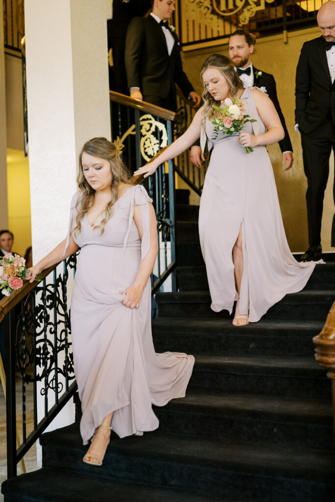 Bridesmaids walking down staircase