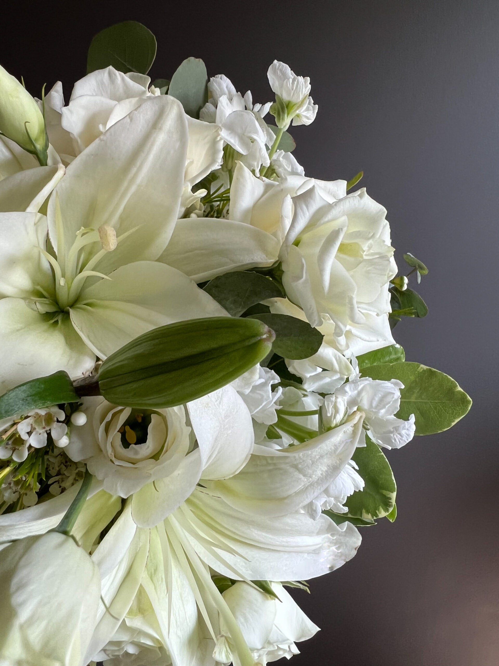 Close up of round bouquet with white lilies