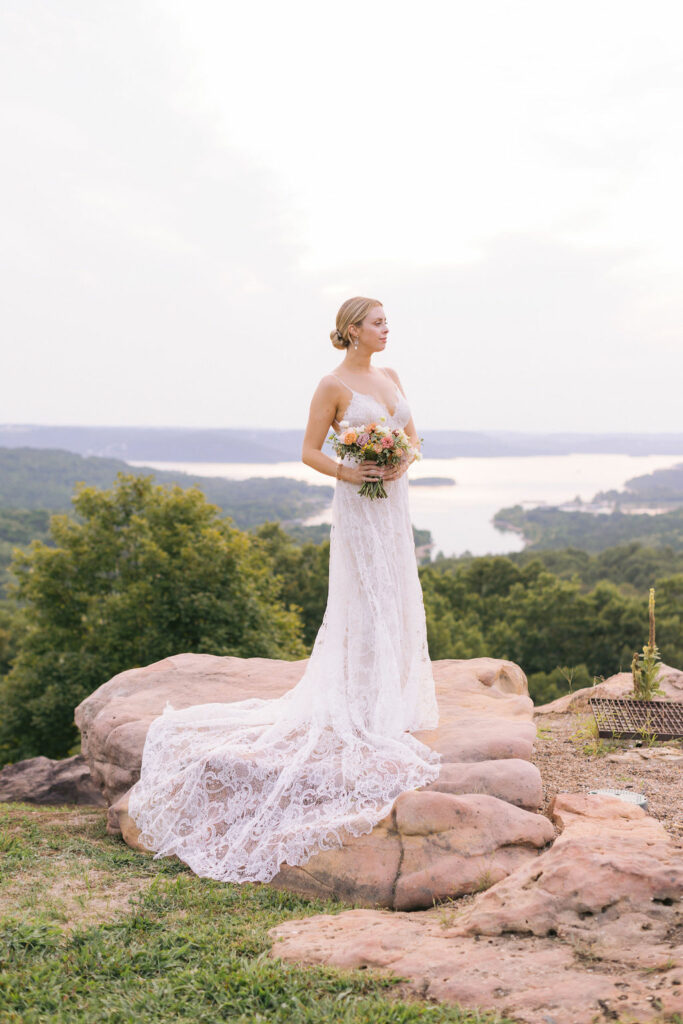 Bride holding bouquet with the lake in the background