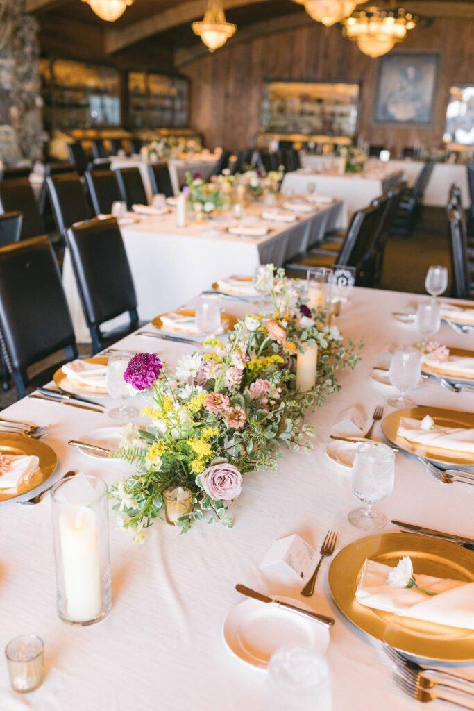 Floral runner centerpiece in the center of a guest table