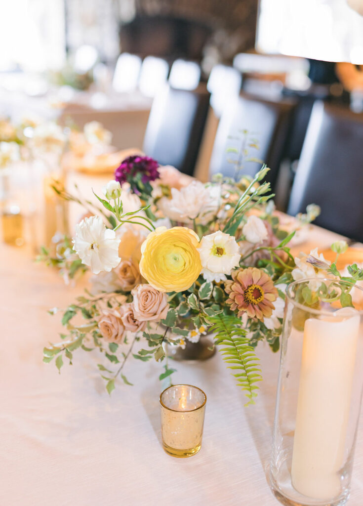 Floral centerpiece in a gold footed compote