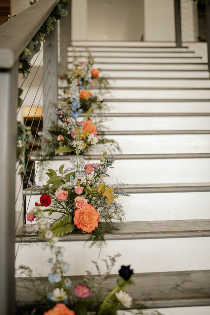 Colorful floral arrangements going up the staircase
