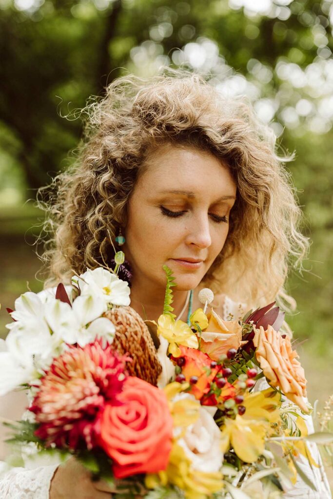 Close up of bride with summery, vibrant bridal bouquet