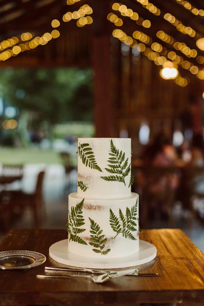 Wedding cake with white frosting and ferns decorating the sides - baked and decorated by Charity Fent Cake Design
