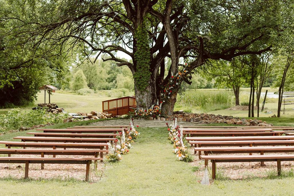 Looking at the ceremony site from behind the last row of seating. Floral Installation and aisle pieces ahead.
