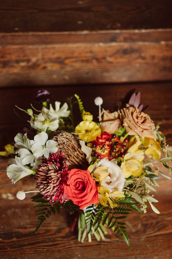 Close up of the bridal bouquet with vibrant, warm summer colors