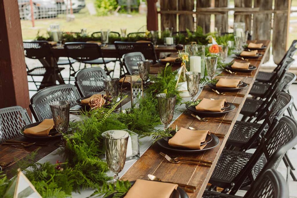 Woodsy table decor for an outdoor wedding reception