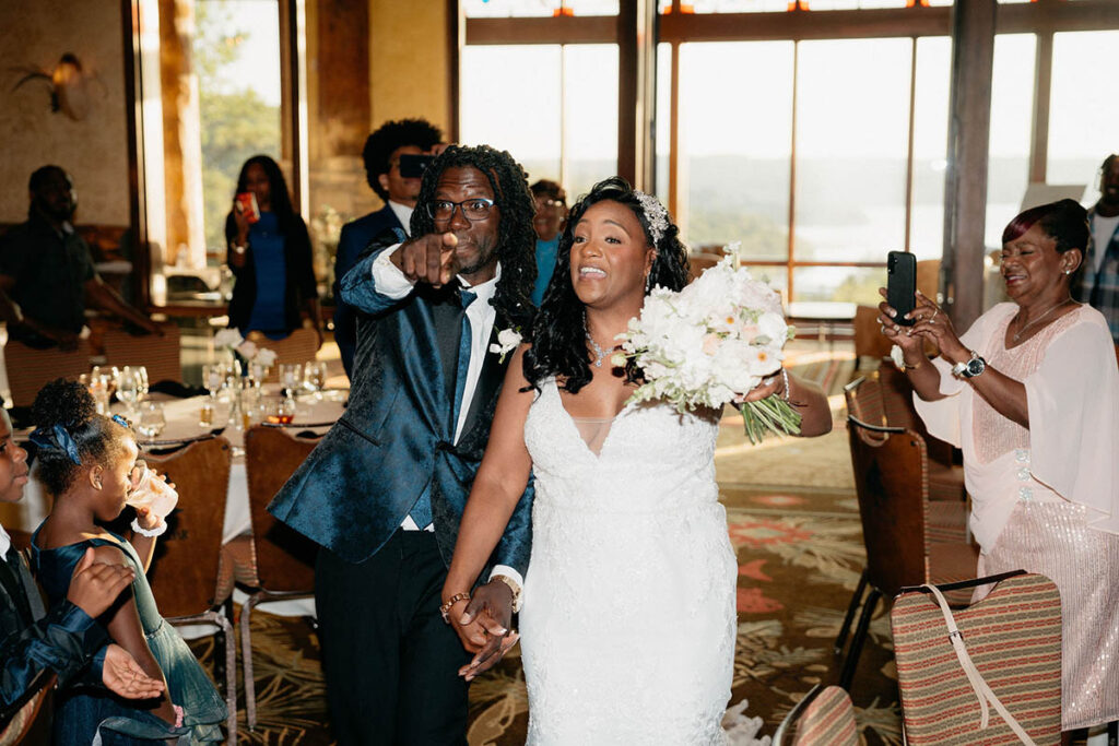 Bride and groom entering the reception space