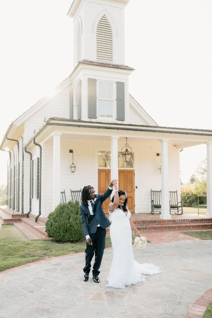 Bride and Groom twirling in front of the Garden Chapel at Big Cedar Lodge