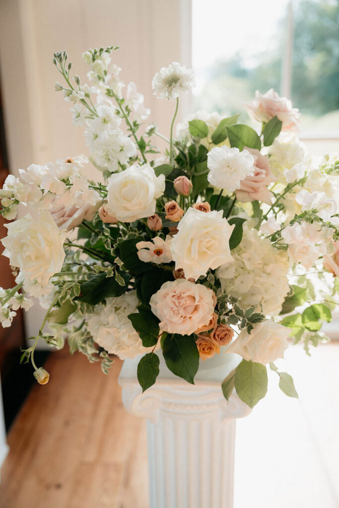 Close up of the second column statement piece with stock, roses, hydrangea, and ranunculus