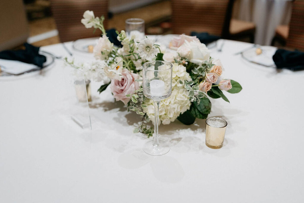 Floral centerpiece with white, blush, and beige flowers